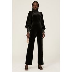 Black velvet (92% Polyester, 8% Spandex). Jumpsuit. Long sleeves. Crewneck. Back zipper closure. See size and fit notes for length measurements. 32" inseam. 13" rise. 20" leg opening. Imported. Fitted Jumpsuits And Rompers For Formal Fall Events, Fitted Formal Jumpsuits And Rompers For Fall, Fitted Formal Jumpsuits And Rompers For Winter, Fitted Velvet Jumpsuit For Party, Fitted Velvet Jumpsuits And Rompers For Party, Sleek Evening Jumpsuits And Rompers For Fall, Elegant Fitted Jumpsuits And Rompers For Winter, Black Velvet Jumpsuit, Spandex Jumpsuit