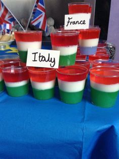 there are many small cups with different colors on them and the name italy is written on each cup