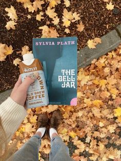 a person is holding up a book about the bell jar by syvia plath