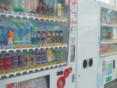 a vending machine with drinks and sodas in it's display case at a convenience store