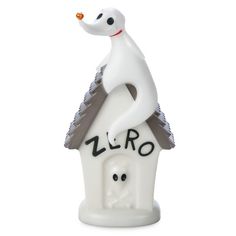 a white ceramic birdhouse with a ghost on it's roof that says zero