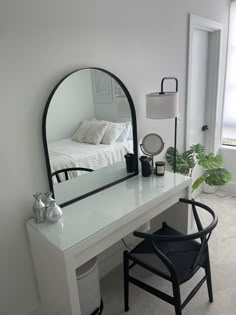 a white desk with a mirror and chair