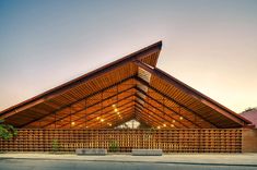 a large wooden building sitting on the side of a road