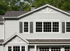 a white house with black shutters and windows