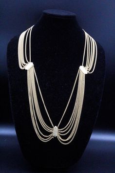 "DESCRIPTION: This is a stunning vintage necklace/belt from the 80s, perfect for adding a touch of glamour to any outfit. The piece is crafted entirely of textured gold plate and designed in a multi-chain manner. It is a festoon piece, with the chains cascading down in a beautiful and elegant way. This necklace/belt is in mint condition and has a hook clasp for secure closure. Measuring 35\" long by 1\" wide, it can be worn as a necklace or a belt, making it a versatile addition to your jewelry Party Gold-plated Double Chain Necklace, Vintage Gold-tone Clavicle Chain Jewelry, Vintage Long Clavicle Chain Necklace, Gold-plated Necklaces For Evening, Gold Double Chain Belt For Party, Elegant Double Chain Belt For Evening, Elegant Gold Chain Belt For Evening, Glamorous Gold Metal Necklace, Elegant Yellow Gold Chain Belt For Formal Occasions