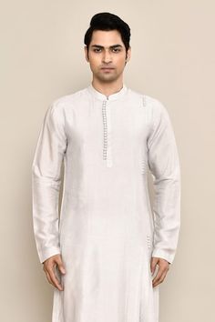 Grey asymmetric kurta featuring potli button detailing. Paired with a solid white pyjama. - Aza Fashions Festive Kurta With Button Cuffs, Festive Traditional Kurta With Button Closure, Straight Kurta With Buttons For Eid, Eid Straight Kurta With Buttons, Traditional White Kurta With Buttons, Potli Button, Asymmetric Kurta, Men Kurta, White Pajamas