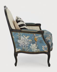 a blue and white chair with flowers on it