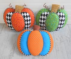 four decorative pumpkins sitting next to each other