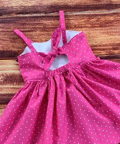 Your little girl will love her fun pink polka dot twirl dress!  So perfect for a birthday gift, a party or everyday fun!   The bodice features a sweetheart neckline and is lined in a white cotton fabric.  The keyhole back ties with a knot with elastic at the back for a comfortable fit. The dress is easy care 100% cotton with the perfect twirling factor!  So much fun for play, parties and dress up occasions. There is an option available for flutter sleeves for a little dressier look. FINISHING: Cute Polka Dot Dress For Birthday, Cute Polka Dot Dress With Ruffles, Fitted Pink Twirl Dress For Playtime, Pink Fitted Twirl Dress For Playtime, Cute Fitted Pink Twirl Dress, Playful Pink Fitted Sundress, Playful Pink Sundress With Ruffles, Playful Pink Ruffled Sundress, Polka Dot Ruffle Dresses For Playtime