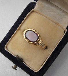 Antique 18K gold signet ring with a garnet stone. With an 18K gold Czech hallmark that was used from 1945. At the side of the ring it has been rasped, which can be seen in the photos. The head of the ring is 0.36 inches (9.2 mm) long and 0.45 inches (11.4 mm) wide. The stone is slightly worn. Size of the stone: 0.24 inches (6.1 mm) long and 0.35 inches (8.8 mm) wide Inside diameter: 0.72 inches (18.4 mm) Size: USA 8.5 UK P½ EU 58 Weight: 4 grams The box is not part of the auction. Free world-wid Vintage Hallmarked Rings For Memorial, Vintage 14k Gold Oval Cabochon Opal Ring, Vintage Gold Opal Cabochon Ring, Vintage Engraved Cabochon Ring For Formal Occasions, Formal Vintage Engraved Ring With Cabochon, Vintage Intaglio Rings For Formal Occasions, Vintage Oval Cabochon Signet Ring For Formal Occasions, Vintage Oval Cabochon Signet Ring For Formal Events, Vintage 14k Stamped Opal Ring For Formal Occasions