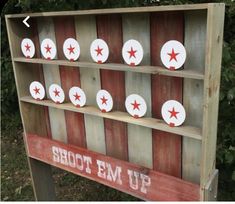 a wooden sign with red and white stars on it