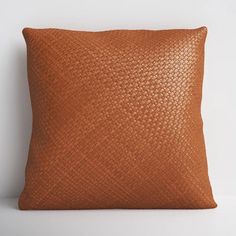 an orange leather pillow on a white background