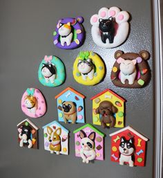 there are many dog magnets on the refrigerator door