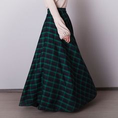 Black and green plaid skirt: - Side seam pockets - Hidden zipper in the side seam - Separate sash - Classic tartan pattern - Fabric is 40% wool, 58% polyviscose, 2% of elastane Model is 6'2'', she wears US 8 size US 0  Bust 82 cm (32.5 inches) Waist 64 cm (25 inches) Hips 89 cm (35 inches) US 2  Bust 85 cm (33.5 inches) Waist 66 cm (26 inches) Hips 92 cm (36 inches) US 4  Bust 88 cm (34.5 inches) Waist 68 cm (27 inches) Hips 94 cm (37 inches)  US 6  Bust 90 cm (35.5 inches) Waist 71 cm (28 inches) Hips 96 cm (38 inches)  US 8  Bust 93 cm (36.5 inches) Waist 74 cm (29 inches) Hips 99 cm (39 inches) US 10  Bust 95 cm (37.5 inches) Waist 76 cm (30 inches) Hips 102 cm (40 inches) US 12  Bust 99 cm (39 inches) Waist 80 cm (31.5 inches) Hips 105 cm (41.5 inches) US 14  Bust 103 cm (40.5 inches) Green Long Winter Skirt, Green Long Skirt For Winter, Winter Long Green Skirt, Long Green Skirt For Fall, Green Lined Maxi Skirt For Fall, Fall Green Lined Maxi Skirt, Green Long Skirt Bottoms For Fall, Green Long Skirt For Fall, Green Pleated Maxi Skirt For Fall