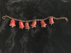 This vintage bracelet has 6 sweet red wooden bells hanging from a simple chain. The clappers in each red bell on the vintage bracelet is a wooden bead with a glass bead on the end. The vintage wooden bell charm bracelet is 7 1/4 inches long and each bell is 7/8 inch long. Bell Bracelet, Simple Chain, Vintage Bracelet, Vintage Bracelets, Charm Bracelets, Glass Bead, Wooden Beads, The Vintage, Glass Beads