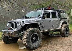 the jeep is driving through some muddy terrain