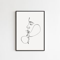 a black and white line drawing of two people kissing each other on a white wall