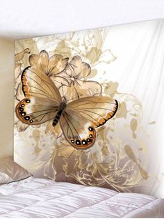 two butterflies flying in the air over a bed