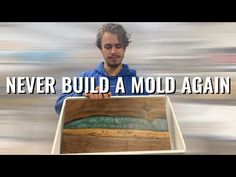 a man holding a wooden box with the words never build a mold again