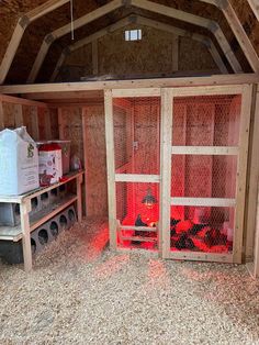 the inside of a chicken coop with chickens in it