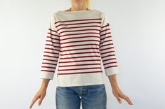 "French vintage Breton shirt - Saint James Made in France 1980s Thick off-white mariniere with red stripes. Straight cut. Boat collar . 3/4 sleeves . Side slits on bottom. Label inside and on left sleeve. In very good condition. 100% cotton Size: F NL D - 40  USA GB - 30 Inter: XS Estimated size: M The model wears usually a size S and measures 170cm - 66,9\".            Measurements taken flat: Shoulders: 38cm - 14,9\" Chest: 40cm - 15,7\" Bottom of shirt: 40cm - 15,7\" Length: 58cm - 22,8\" Sleeves: Length: 46cm - 18,1\" Width: 18cm - 7\" Wrist : 12cm - 4,7\" Please note that our items are vintage and may have slight imperfections. For more details, product information or additional photos, please do not hesitate to contact us." Breton Shirt, Sailor Shirt, Saint James, Modern Fabric, Straight Cut, French Vintage, Vintage Outfits, Adult Outfits, Stripes