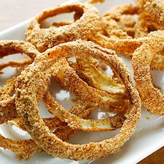 fried onion rings on a white plate ready to be eaten