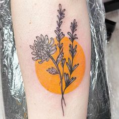 an orange with some flowers on it