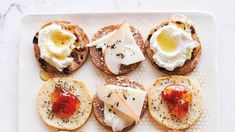 an assortment of breads with eggs and cheese on them