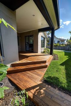 a wooden deck in front of a house