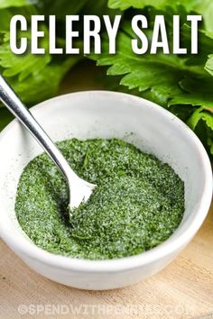 a white bowl filled with green herbs and the words celery salt