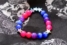 Bisexual/Biromantic pride flag star beaded gemstone bracelet. The beads are the bi flag colors (pink, purple, blue) and holographic stars. ♥ Bracelet Size: - To find the size that fits you best, you can measure the circumference around your wrist; for a comfort/loose fit, add 2cm to that measurement ♥ Handcrafted With: ✔ High-quality gemstone beads ✔ Durable stretchy cord Thank you for visiting! If you have any questions, feel free to contact me!  Instagram: @FrogsMakingToast Bi Bracelet, Bisexual Bracelet, Lgbtq Bracelet, Lgbtq Gifts, Bi Flag, Bisexual Flag, Stretchy Beaded Bracelet, Pride Bracelet, Crystal Beads Bracelet