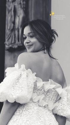 a black and white photo of a woman in a dress