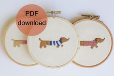 three embroidery hoops with small dogs on them