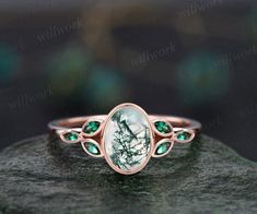 This ring is handmade by myself. The main stone is a 6x8mm oval cut natural moss agate . The accent stones are marquise 1.5x3mm lab emeralds. The band width is about 1.4mm. The material is solid 14k gold(white,yellow,rose gold is also available) Ring size can be choose from the selection box. This jewelry can also be made in solid 10k,14k,18k gold,with real diamonds.Contact me! Need rush order? contact me! Need custom making order? Contact me! I have confidence on my jewelry.30 days money back g Moss Agate And Emerald Engagement Ring, Handmade Elegant Emerald Ring Oval Cabochon, Handmade Elegant Emerald Oval Cabochon Ring, Oval Emerald Rose Gold Jewelry, Rose Gold Oval Emerald Ring, Oval Emerald Ring In Rose Gold, Engagement Ring Marquise Cut, Purple And Green Wedding, Engagement Ring Marquise