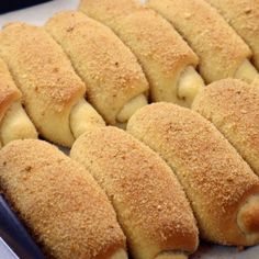 several pieces of bread sitting on top of a baking pan filled with doughnuts