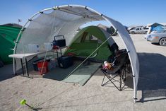 the tent is set up in the parking lot for people to sit outside and watch