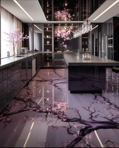 an elegant kitchen with marble floors and pink flowers on the countertop, along with chandeliers