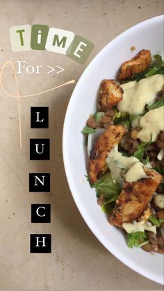 a white bowl filled with food on top of a table next to a sign that says time for lunch