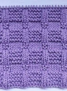 a purple knitted dishcloth on a white surface