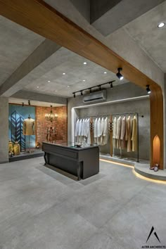 the inside of a clothing store with clothes on racks