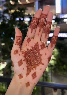 a woman's hand with henna on it