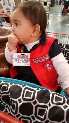 a small child sitting in a shopping cart