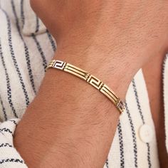 "Explore our 14K Solid Gold Greek Key Bracelet, a timeless and classic addition to men's jewelry. Crafted with care, this real gold bangle showcases intricate Greek key motifs and is handmade to perfection. With its waterproof design, it's not just a stylish choice, but also a durable one, making it an ideal gift for men. -- ⋆ This product is designed with Runda's fine handcrafting with sustainable methods. ⋆ Express-insured shipping to the whole world and delivery to cargo in only 3 business days. ⋆ Free return and warranty Product Details * 14K Real Solid Gold * 10 GR for 7,5\" Length - 7MM Width * Customizable Size * Yellow - White - Rose Gold Available * Lobster Claw Clasp * Hypoallergenic * Model No BXB151768-1 -- ♻️ UPCYCLING THE FUTURE A more sustainable future is determined with ou Gold Bracelet Men, Mens Bracelet Gold Jewelry, Man Gold Bracelet Design, Real Gold Bracelet, Key Bracelet, Mens Gemstone Rings, Fancy Jewellery Designs, Mens Gold Jewelry, Gold Armband