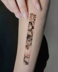 a woman's arm with a cat tattoo on it