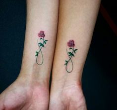 two matching tattoos with roses on their wrist