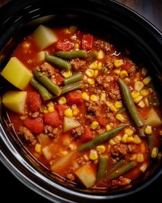 a crock pot filled with stew and vegetables