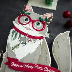 a close up of a cat with glasses and a ribbon on it's neck