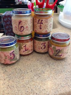 there are many jars with numbers on them sitting on the counter next to each other