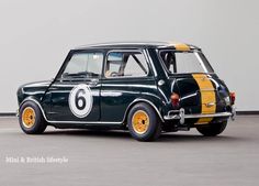 an old black car with yellow and white stripes