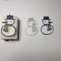 two rubber stamps with snowmen drawn on them